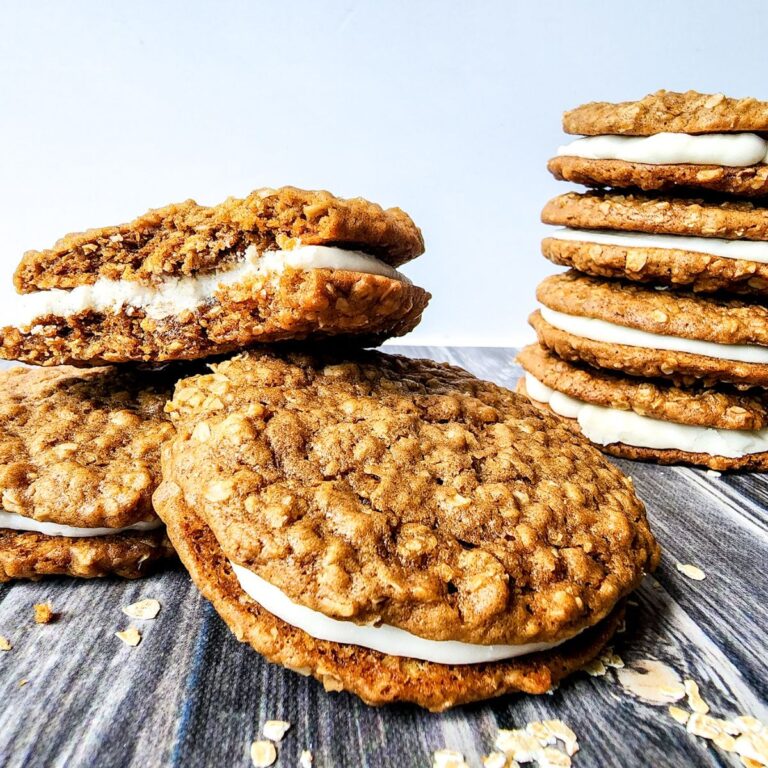 Two stacks of homemade oatmeal cream pies one broken in half.