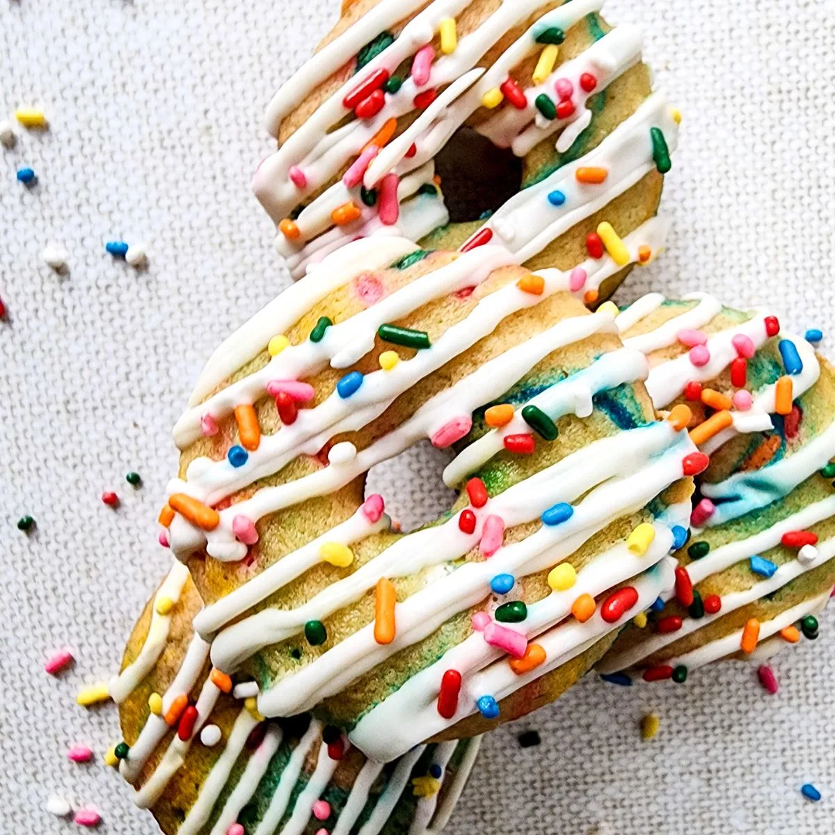 Close up looking at a pile of funfetti donnuts.