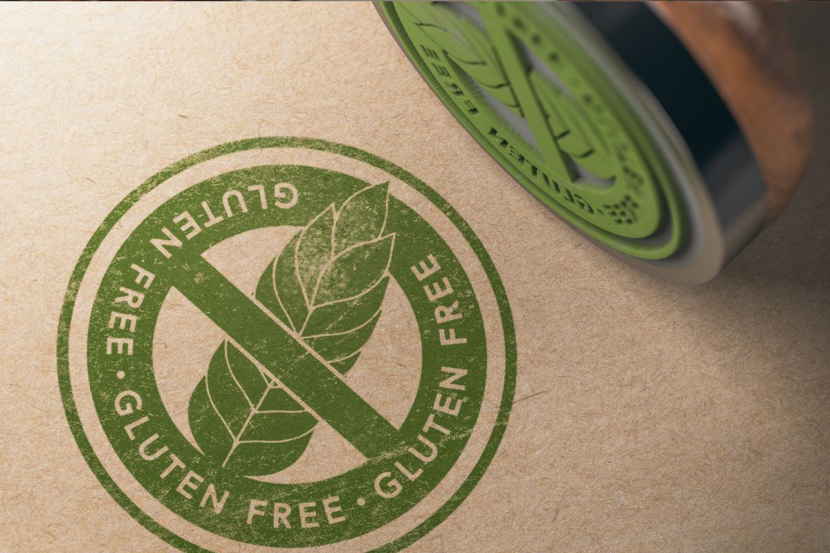 A green gluten free stamp on paper with the stamper on its side. 