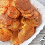 Looking closely at some fried potato crisps and fried onions.