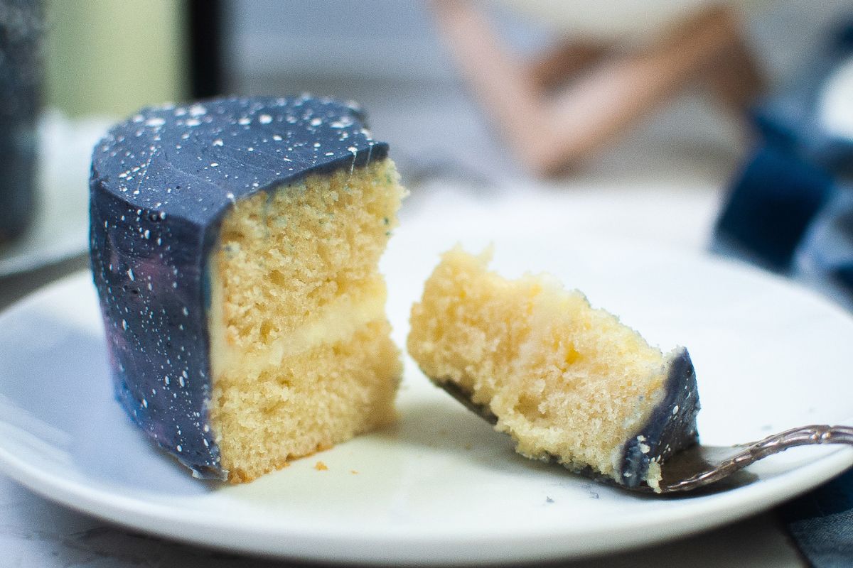 A bite of galaxy cake sitting next to the rest of the piece fo cake.