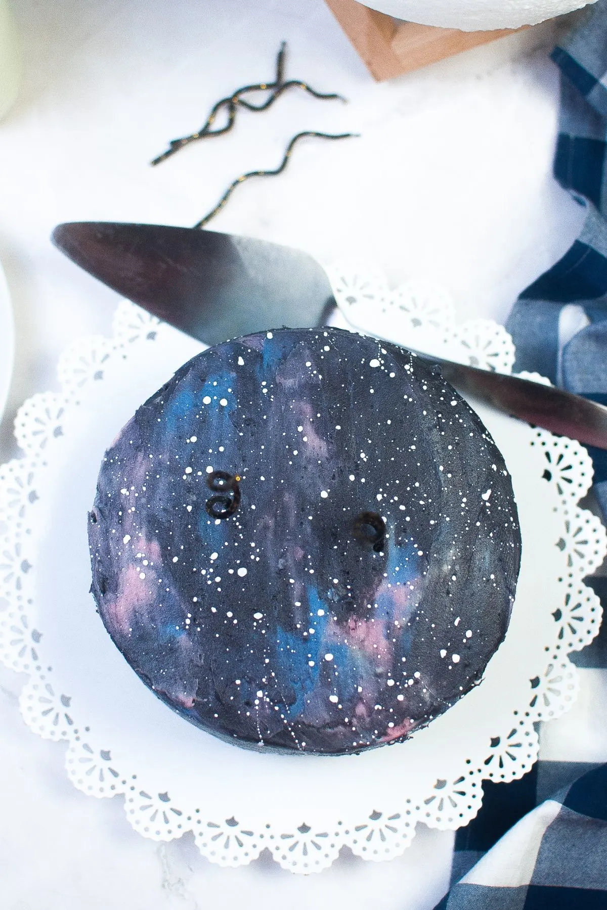 Looking down on a galaxy cake on a cake plate.