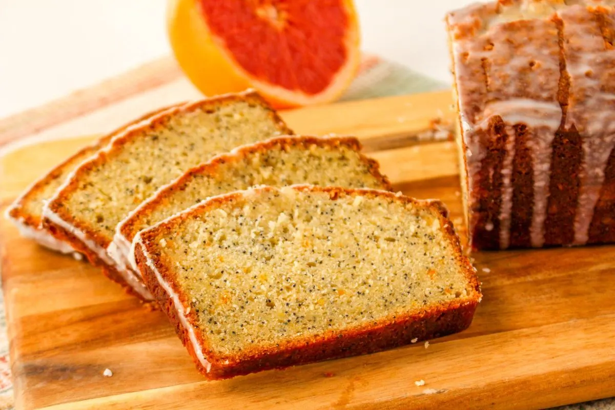 Four slices of grapefruit bread or a cutting board next to the rest of the loaf.