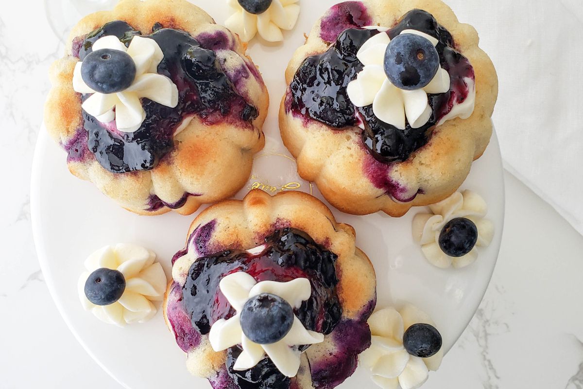 Looking down on 3 lemon and blueberry mini bundt cakes.