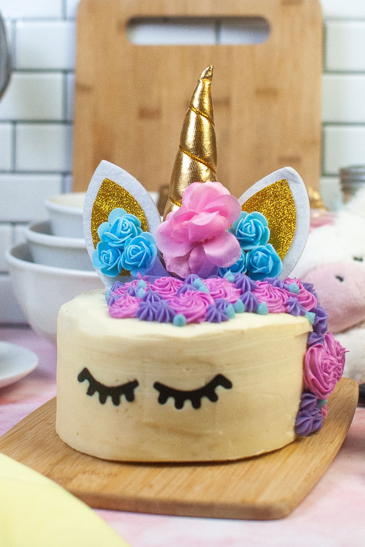 A cake that is frosted to look like a unicorn.