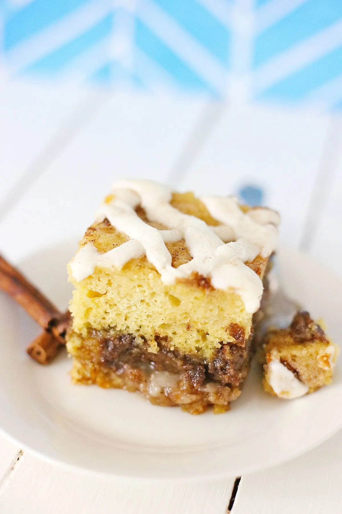 A piece of a cinnabon cake on a plate.