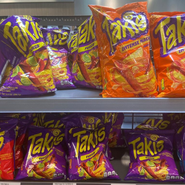 Two shelves full of Takis bags of different flavors.