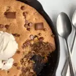A couple bites of a Gluten Free pizookie in a cast iron skillet.