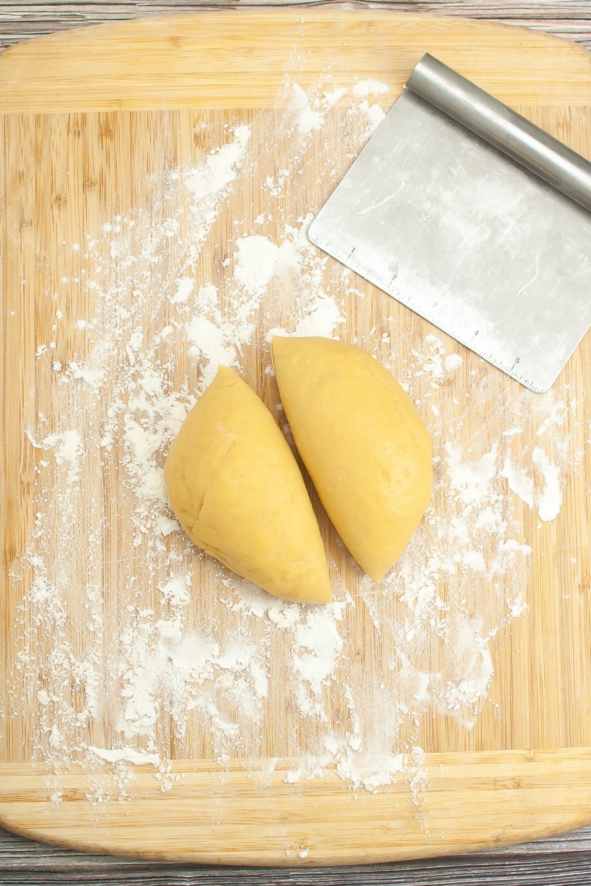 A ball of pasta dough cut into two. 