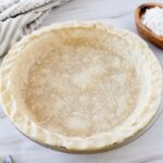 A gluten free pie crust in a pie pan.