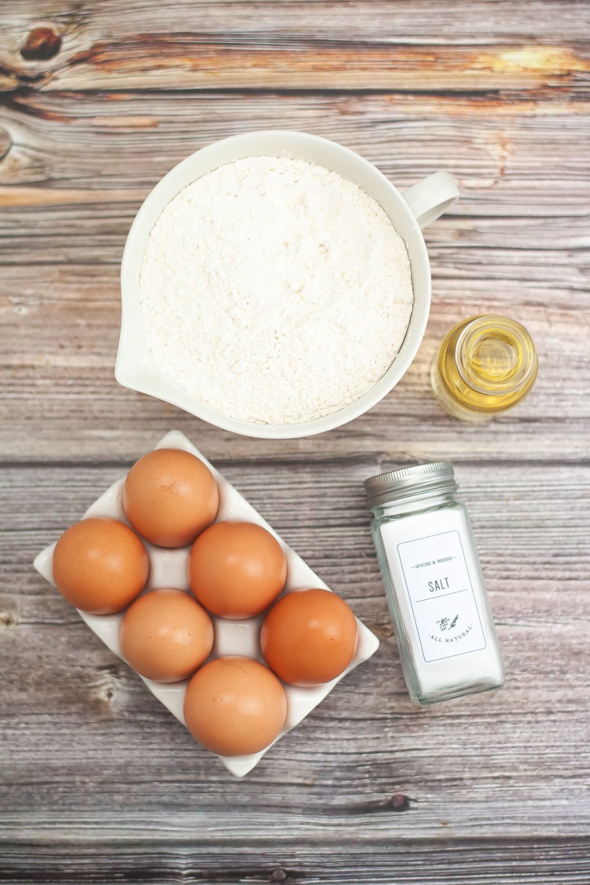 Ingredients needed to make homemade gluten free fettucinne, gluten free pasta flour, eggs olive oil, and salt. 