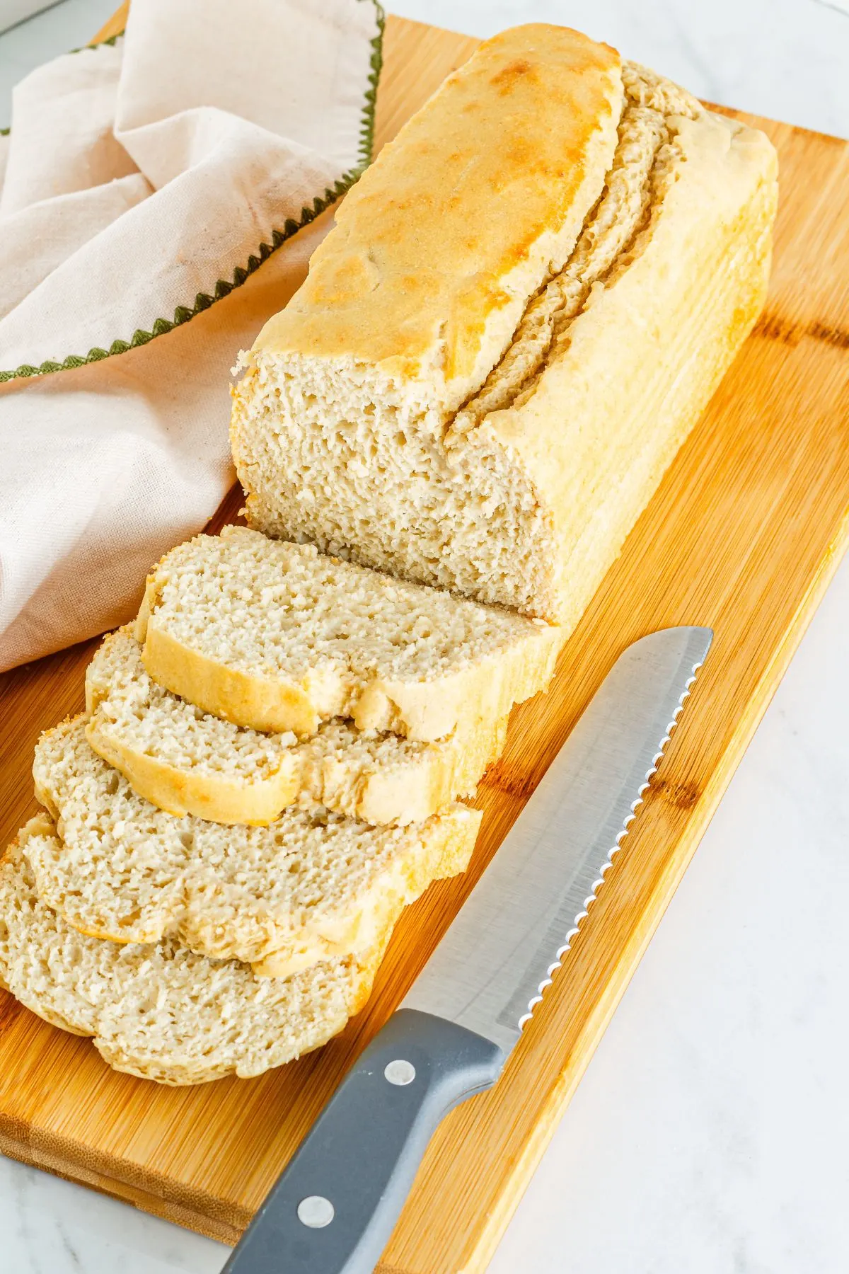 Sliced bread on a cutting board- gluten free bread. 